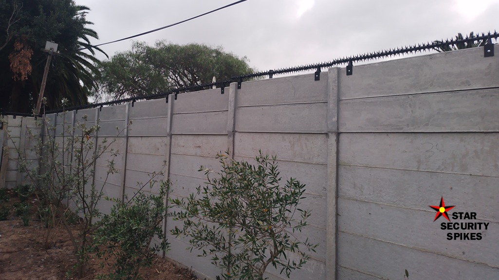 a concrete wall with Rotating Spikes